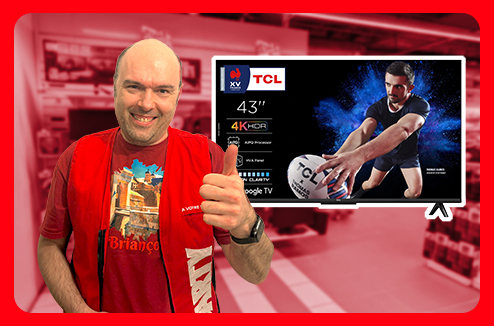 Un vendeur Darty fait le signe OK à côté d'un TV 4K TCL