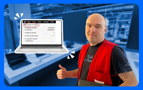 Un vendeur Darty à côté d'un Macbook