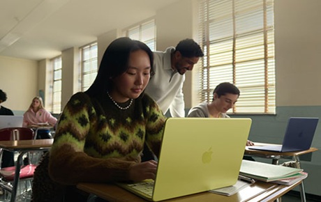 Une jeune femme utilise son MacBook Neo dans une salle de cours