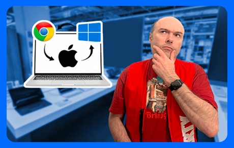 Un vendeur Darty l'air pensif à côté d'un PC portable affichant les logos des principaux OS du marché